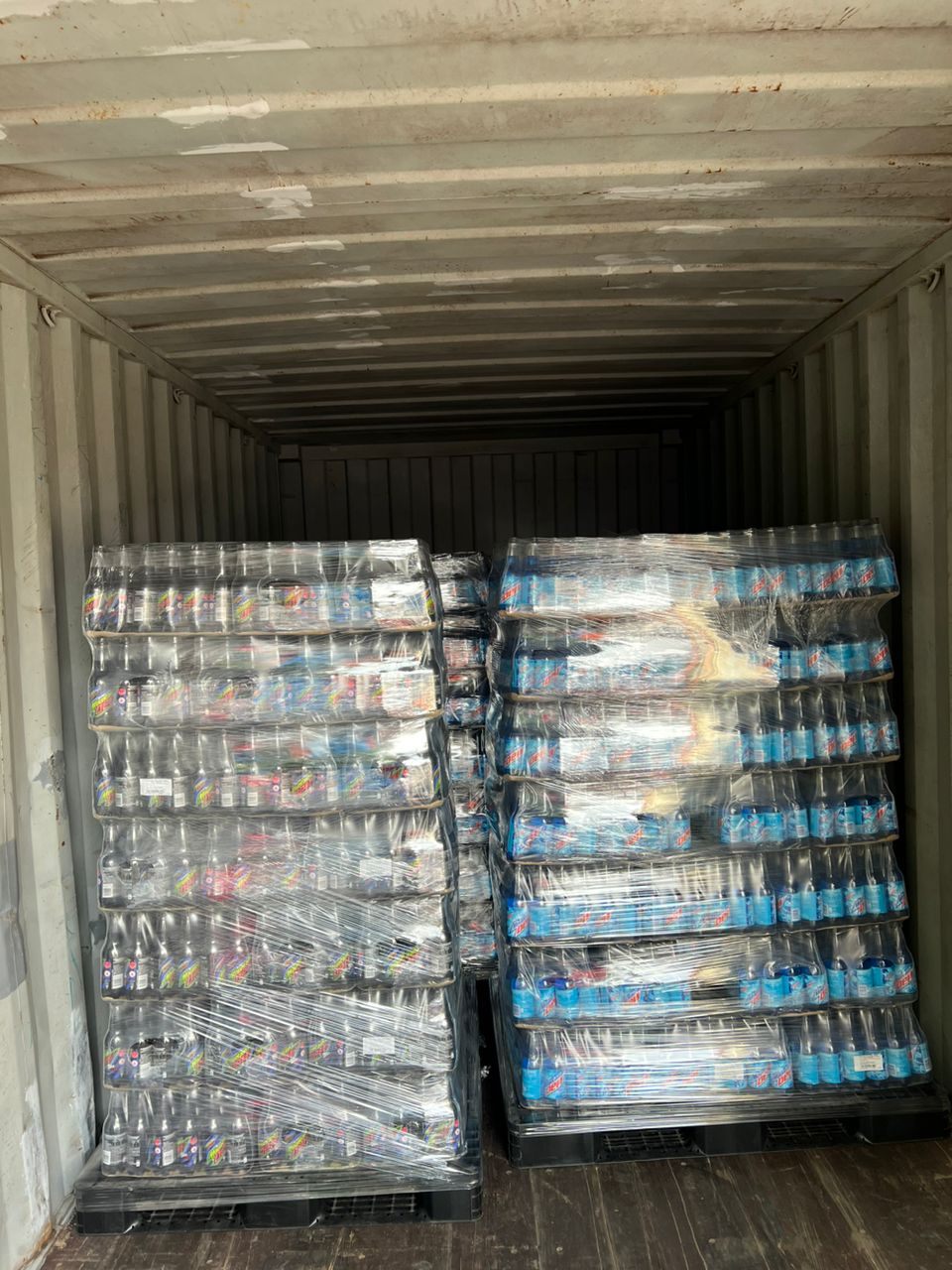 Bottled beverages palletised inside a shipping container for export